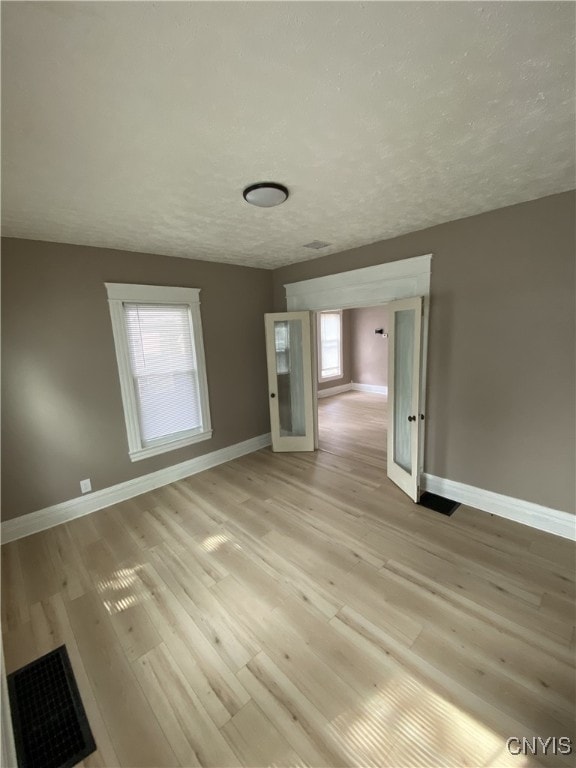 409 W 1st St S, Fulton, NY 13069 - empty room with light wood-type flooring and a textured ceiling
