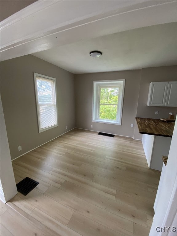 409 W 1st St S, Fulton, NY 13069 - unfurnished dining area with light wood-style flooring and baseboards