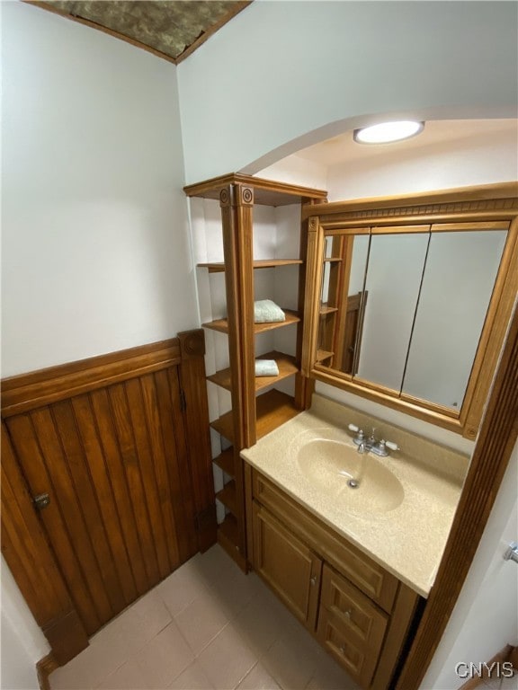 409 W 1st St S, Fulton, NY 13069 - bathroom featuring wainscoting, vanity, and tile patterned floors