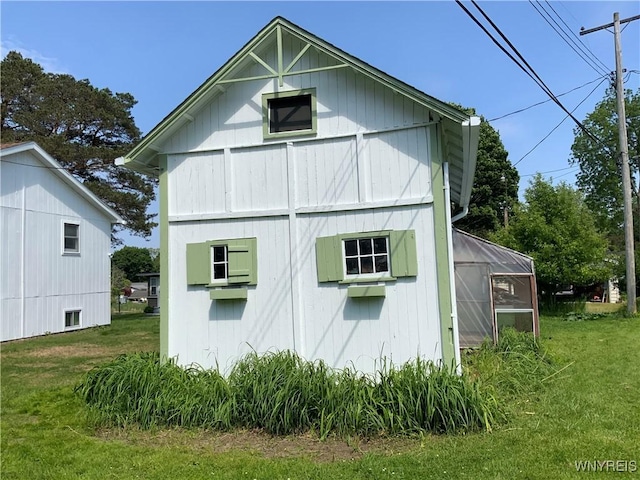 926 Bluff Rd, Carlton, NY 14571 - view of side of home with a greenhouse, an outdoor structure, and a lawn