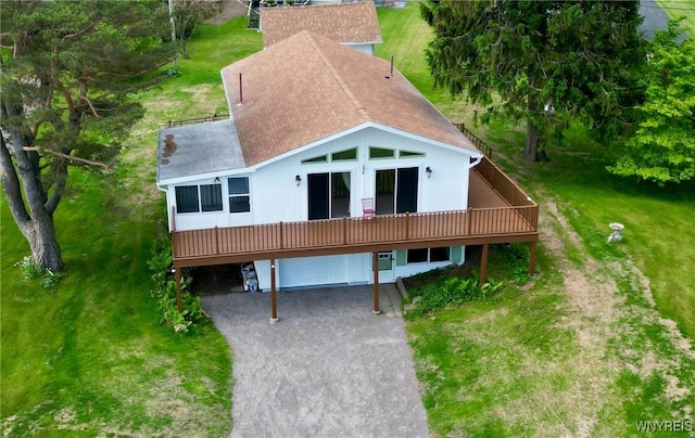926 Bluff Rd, Carlton, NY 14571 - back of property with driveway, a wooden deck, a garage, a shingled roof, and a yard