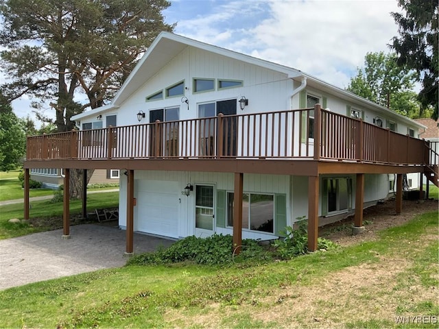 926 Bluff Rd, Carlton, NY 14571 - back of house featuring a garage, driveway, a deck, and a yard