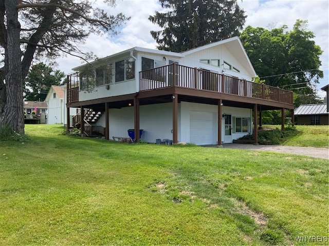 926 Bluff Rd, Carlton, NY 14571 - rear view of property featuring a wooden deck, a lawn, driveway, a garage, and stairway