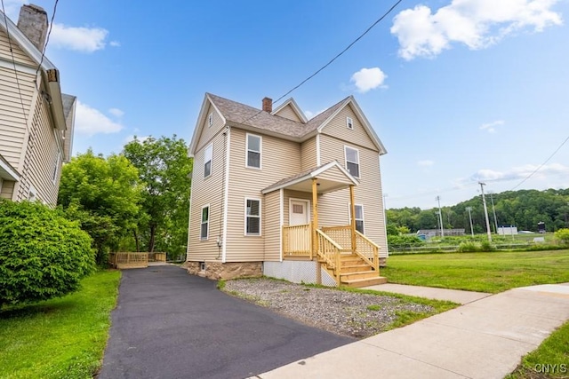 21 Frederick St, German Flatts, NY 13357 - view of front of home featuring a chimney and a front lawn