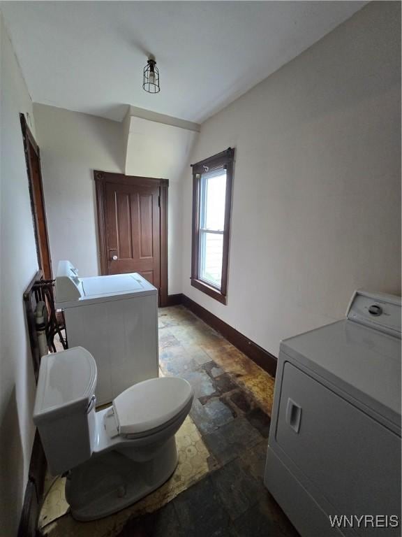 213 Highland Ave, Shelby, NY 14103 - bathroom featuring stone finish floors and washing machine and clothes dryer