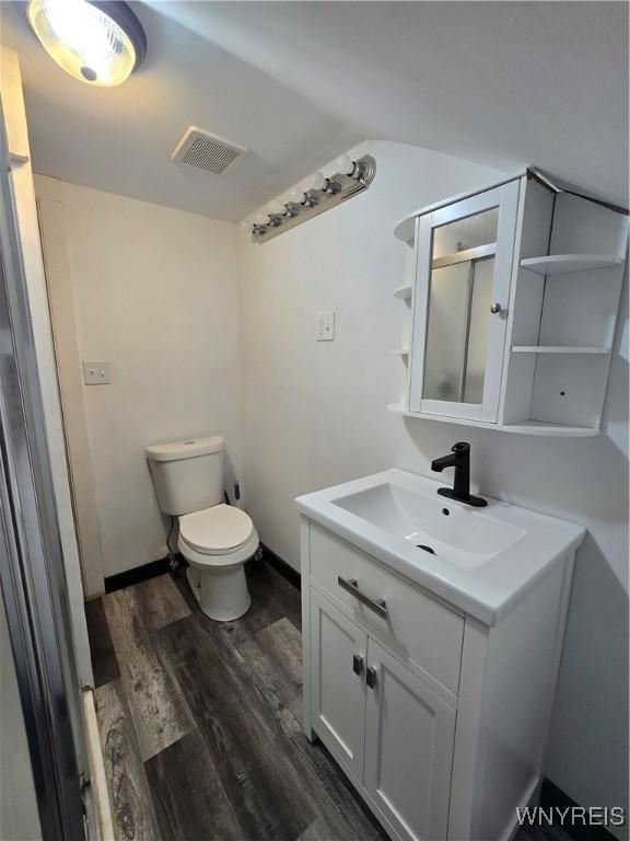 213 Highland Ave, Shelby, NY 14103 - bathroom with vanity and wood finished floors