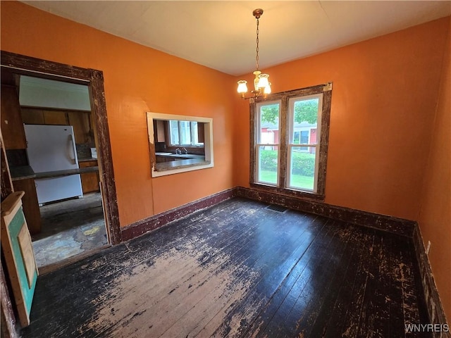 213 Highland Ave, Shelby, NY 14103 - unfurnished room with a chandelier and wood-type flooring