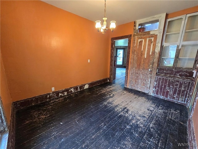 213 Highland Ave, Shelby, NY 14103 - spare room featuring a chandelier and wood finished floors