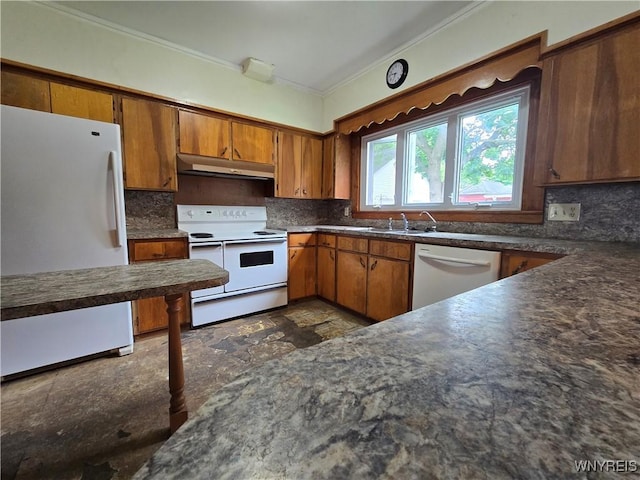 213 Highland Ave, Shelby, NY 14103 - kitchen with white appliances, under cabinet range hood, dark countertops, crown molding, and brown cabinets