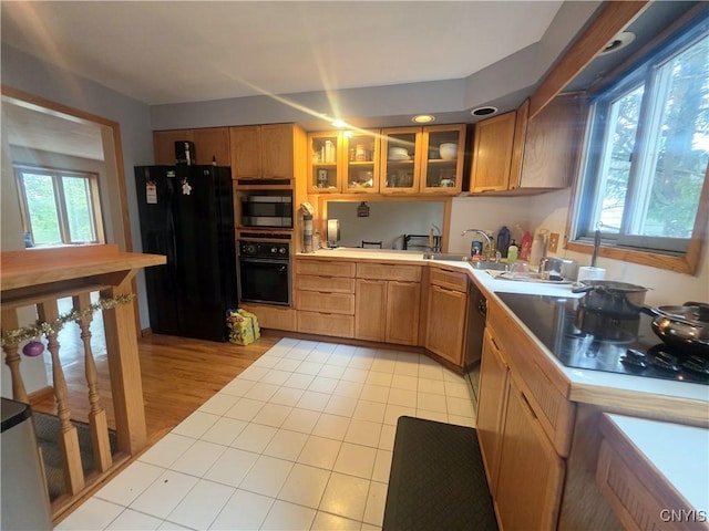 244 Scottholm Ter, Syracuse, NY 13224 - kitchen with black appliances, light countertops, glass insert cabinets, brown cabinets, and light tile patterned flooring