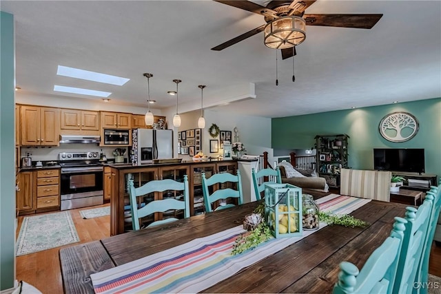 8272 Northgate Dr, Rome-Outside, NY 13440 - dining space with a skylight, light wood-style flooring, and ceiling fan