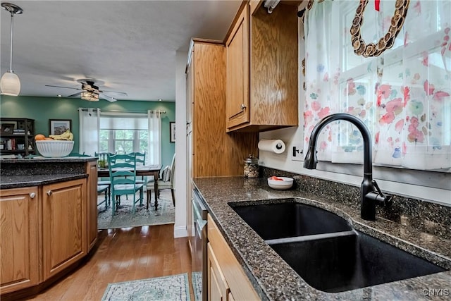 8272 Northgate Dr, Rome-Outside, NY 13440 - kitchen featuring wood finished floors, decorative light fixtures, ceiling fan, dark stone countertops, and stainless steel dishwasher