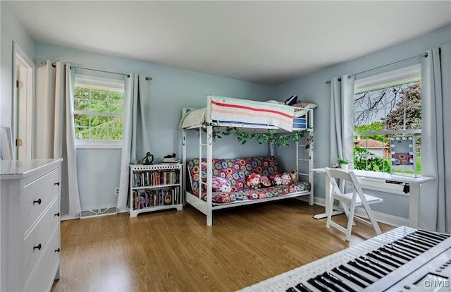8272 Northgate Dr, Rome-Outside, NY 13440 - bedroom featuring multiple windows and wood finished floors