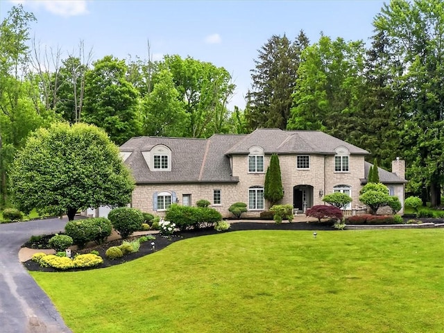 1010 Plank Rd, Penfield, NY 14580 - french country home featuring a front lawn and stone siding