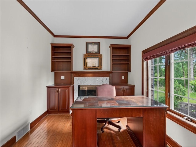 1010 Plank Rd, Penfield, NY 14580 - home office with light wood-type flooring, plenty of natural light, crown molding, and a premium fireplace