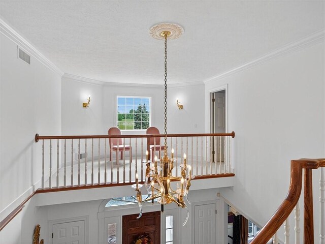 1010 Plank Rd, Penfield, NY 14580 - staircase featuring a chandelier and ornamental molding
