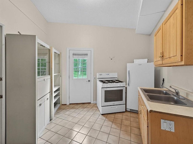 1010 Plank Rd, Penfield, NY 14580 - kitchen with white appliances, light tile patterned floors, light brown cabinets, and light countertops
