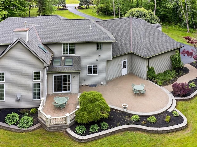 1010 Plank Rd, Penfield, NY 14580 - back of property featuring a patio area, roof with shingles, a yard, and outdoor dining space