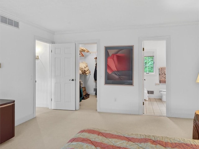 1010 Plank Rd, Penfield, NY 14580 - carpeted bedroom featuring a spacious closet, ornamental molding, ensuite bathroom, and a closet