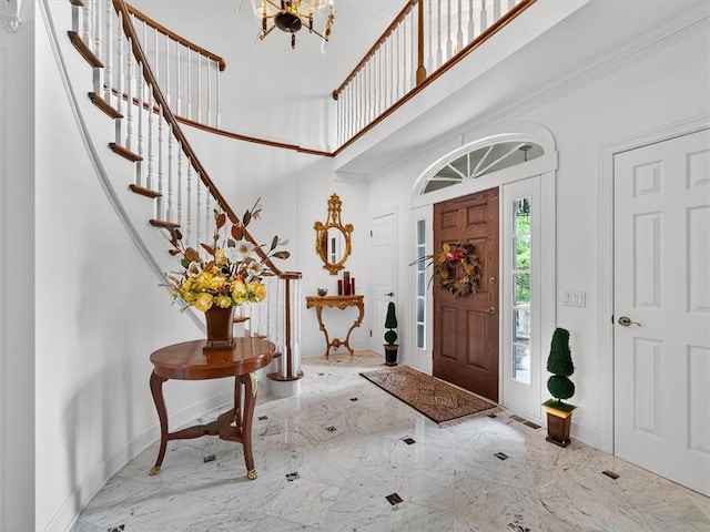 1010 Plank Rd, Penfield, NY 14580 - foyer featuring a high ceiling, marble tiled floors, stairway, and a chandelier