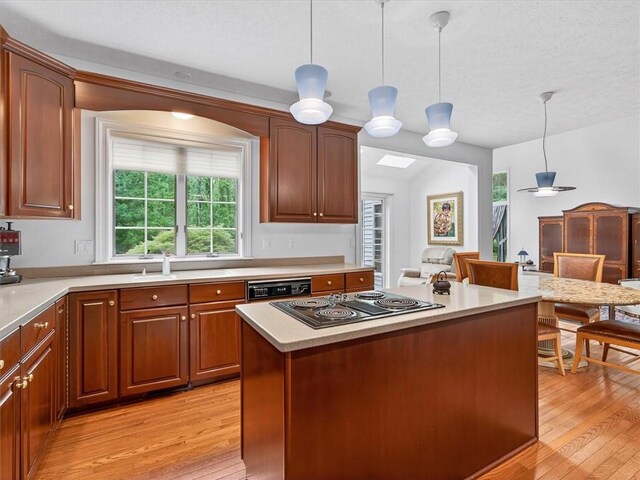 1010 Plank Rd, Penfield, NY 14580 - kitchen featuring black electric stovetop, light wood finished floors, pendant lighting, light countertops, and a textured ceiling
