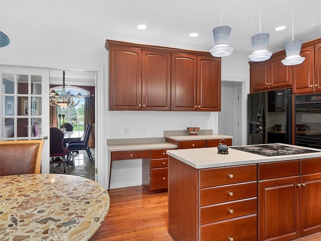 1010 Plank Rd, Penfield, NY 14580 - kitchen with black appliances, light countertops, a chandelier, light wood finished floors, and pendant lighting