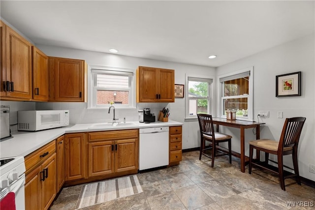 124 Allenhurst Rd, Amherst, NY 14226 - kitchen with white appliances, brown cabinets, light countertops, backsplash, and recessed lighting
