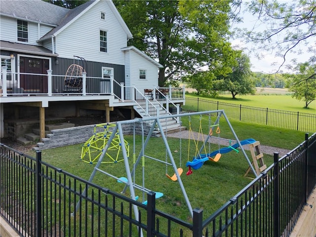 7046 Safford Ave Unit 12, Castile, NY 14530 - fenced backyard featuring a playground, a wooden deck, and stairway