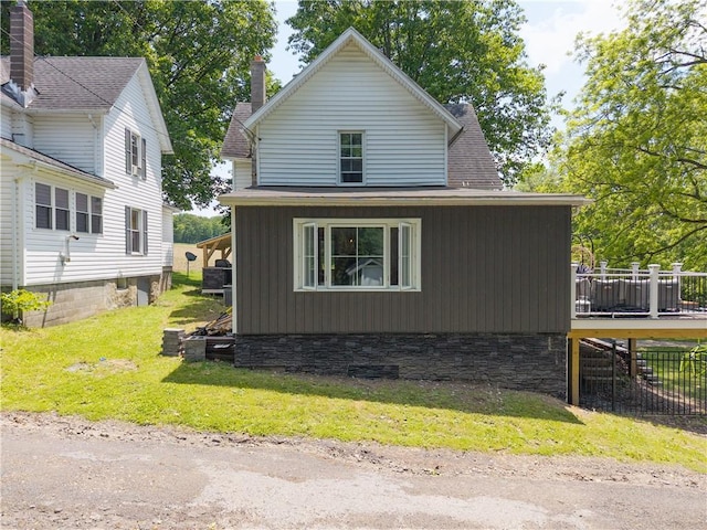 7046 Safford Ave Unit 12, Castile, NY 14530 - view of property exterior with a wooden deck and a lawn