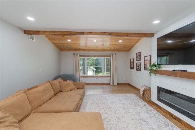 7046 Safford Ave Unit 12, Castile, NY 14530 - living room featuring recessed lighting, a wooden ceiling with exposed beams, wood finished floors, a glass covered fireplace, and wooden walls