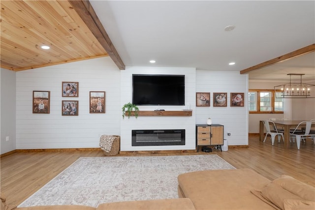 7046 Safford Ave Unit 12, Castile, NY 14530 - living room featuring wood finished floors, recessed lighting, a glass covered fireplace, a chandelier, and wooden walls