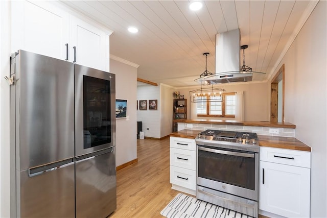 7046 Safford Ave Unit 12, Castile, NY 14530 - kitchen with stainless steel appliances, island exhaust hood, crown molding, white cabinets, and wooden counters