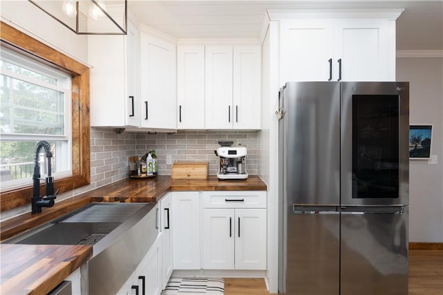 7046 Safford Ave Unit 12, Castile, NY 14530 - kitchen with smart refrigerator, butcher block countertops, backsplash, ornamental molding, and light wood-style floors