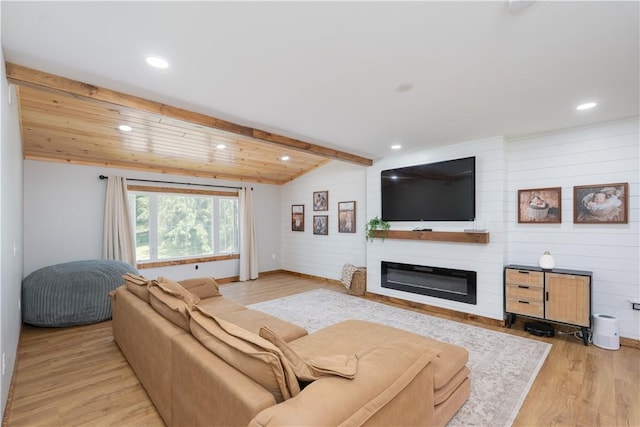 7046 Safford Ave Unit 12, Castile, NY 14530 - living room featuring a glass covered fireplace, recessed lighting, wooden walls, wood finished floors, and beamed ceiling