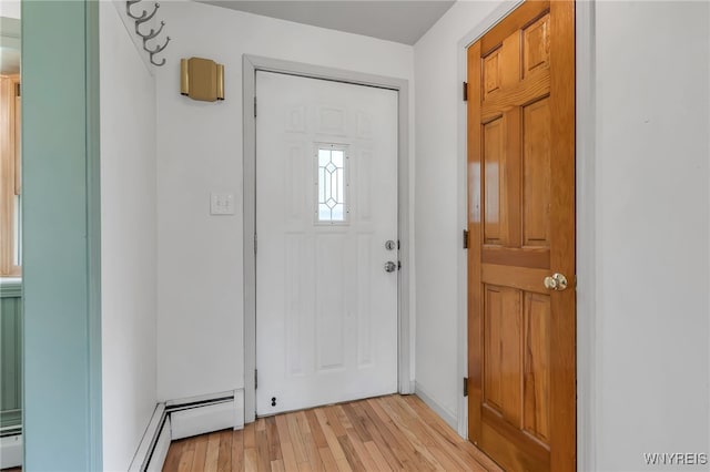 4306 Shimerville Rd, Clarence, NY 14031 - foyer entrance featuring light wood finished floors and a baseboard heating unit