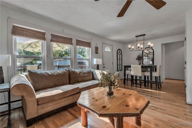4306 Shimerville Rd, Clarence, NY 14031 - living area featuring a chandelier, ceiling fan, light wood finished floors, and a baseboard heating unit