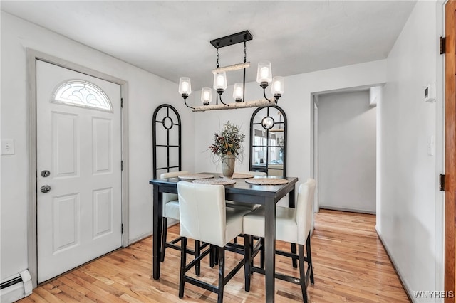 4306 Shimerville Rd, Clarence, NY 14031 - dining room featuring baseboard heating, light wood-style flooring, and a chandelier