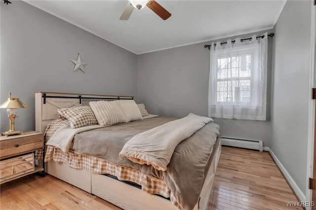 4306 Shimerville Rd, Clarence, NY 14031 - bedroom with baseboard heating, wood finished floors, ornamental molding, and ceiling fan