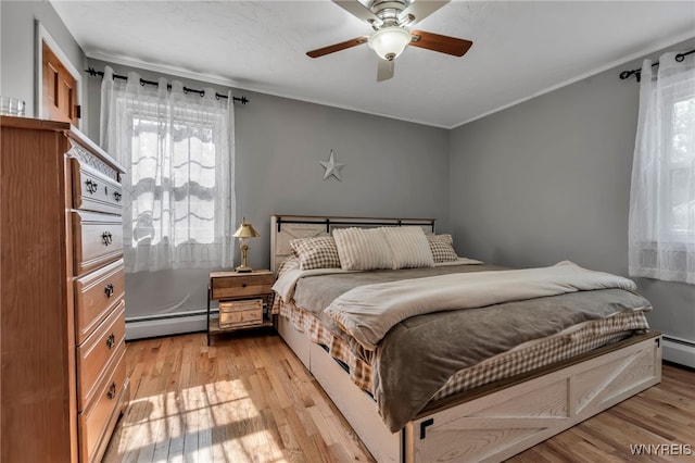 4306 Shimerville Rd, Clarence, NY 14031 - bedroom featuring a baseboard heating unit, multiple windows, light wood finished floors, and ornamental molding
