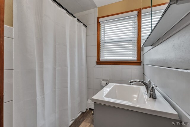 4306 Shimerville Rd, Clarence, NY 14031 - bathroom featuring vanity, tile walls, wood finished floors, and a shower with shower curtain