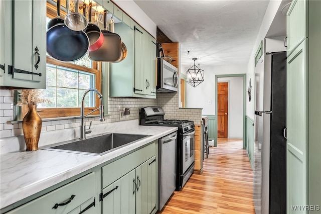 4306 Shimerville Rd, Clarence, NY 14031 - kitchen featuring green cabinets, stainless steel appliances, and light wood finished floors