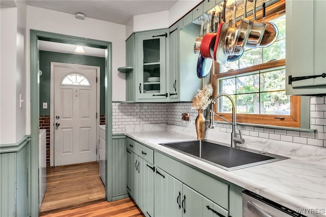 4306 Shimerville Rd, Clarence, NY 14031 - kitchen featuring green cabinets, stainless steel dishwasher, light countertops, light wood-style floors, and healthy amount of natural light