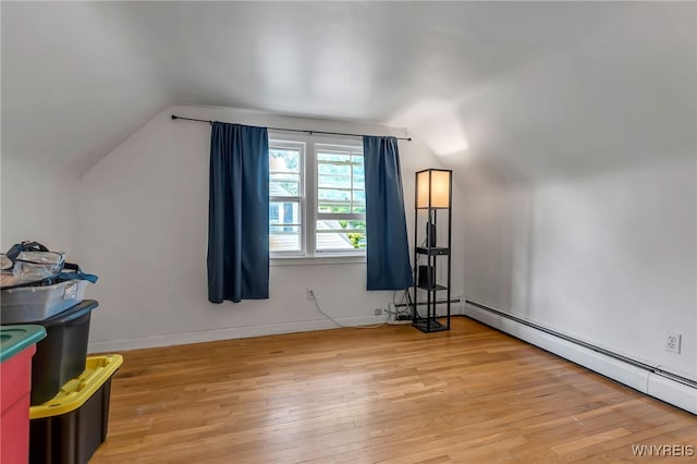 4306 Shimerville Rd, Clarence, NY 14031 - additional living space featuring vaulted ceiling, light wood-style floors, and a baseboard radiator