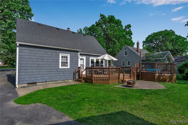 4306 Shimerville Rd, Clarence, NY 14031 - back of property with a deck, a fire pit, a lawn, a patio, and roof with shingles