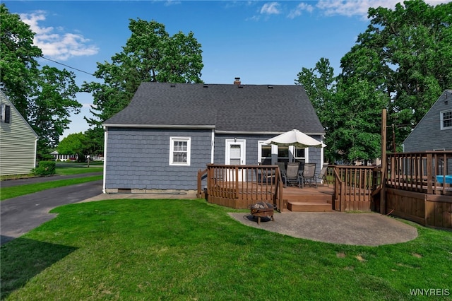 4306 Shimerville Rd, Clarence, NY 14031 - back of house featuring a wooden deck, a yard, roof with shingles, and a chimney