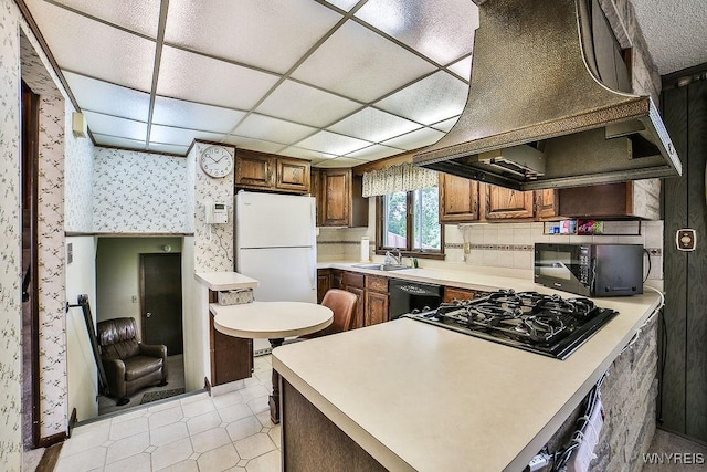 48 Kibler Dr, Lancaster, NY 14043 - kitchen with custom range hood, black appliances, wallpapered walls, light countertops, and a peninsula