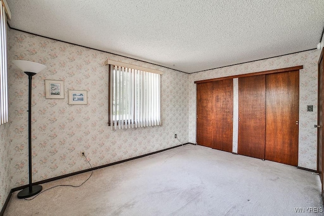 48 Kibler Dr, Lancaster, NY 14043 - unfurnished bedroom with a textured ceiling, carpet floors, and wallpapered walls