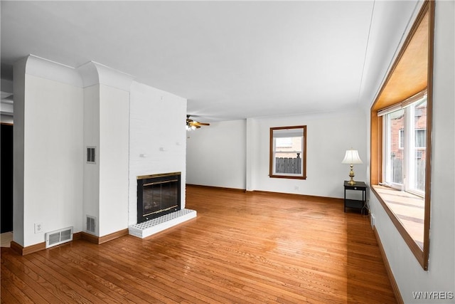 482 Loretta St, Tonawanda-Town, NY 14223 - unfurnished living room featuring hardwood / wood-style flooring, a fireplace, and a ceiling fan