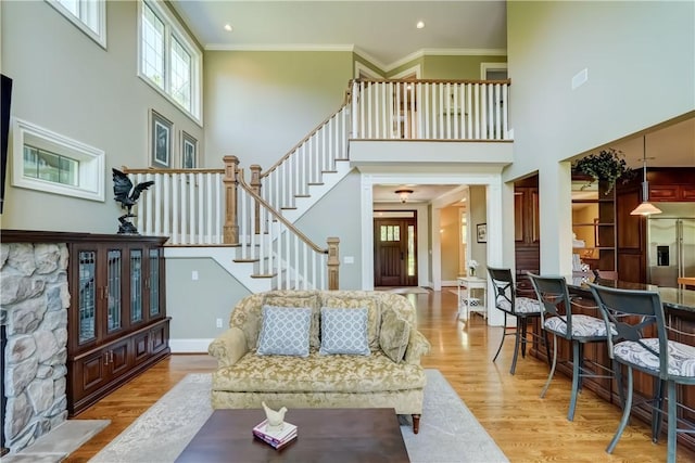 393 Mendon Center Rd, Mendon, NY 14472 - living area featuring a high ceiling, wood finished floors, stairway, crown molding, and recessed lighting