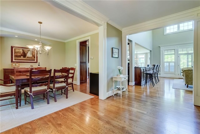 393 Mendon Center Rd, Mendon, NY 14472 - dining space featuring a chandelier, wood finished floors, and ornamental molding